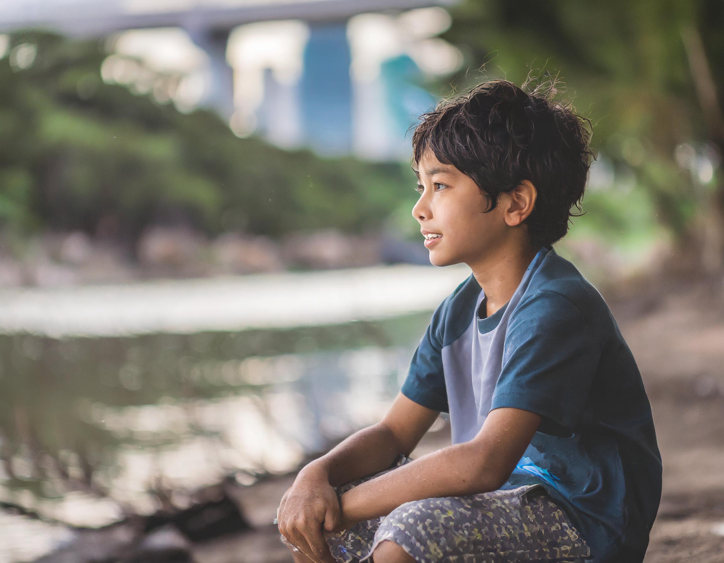 Firefly homeless 10 year old philippines boy, sitting near a river in manilla. dirty clothes, grimy (1)